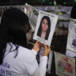 
              The photo of a missing person is part of an improvised altar at La Palma roundabout on The International Day of the Disappeared during an march along the Paseo de la Reforma street by families who want the government help locate their missing relatives in Mexico City, Tuesday, Aug. 30, 2022. The roundabout, where a palm tree used to stand but was removed, has been adopted by the families of missing people and coined "The roundabout of the disappeared."  (AP Photo/Eduardo Verdugo)
            
