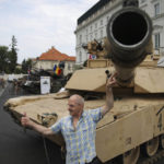 
              People attend a military picnic marking the Polish Army Day in Warsaw, Poland, Monday, Aug. 15, 2022. The Polish president and other officials marked their nation's Armed Forces Day holiday Monday alongside the U.S. army commander in Europe and regular American troops, a symbolic underlining of NATO support for members on the eastern front as Russia wages war nearby in Ukraine. (AP Photo/Michal Dyjuk)
            