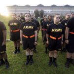 
              Students in the new Army prep course stand at attention after physical training exercises at Fort Jackson in Columbia, S.C., Saturday, Aug. 27, 2022. The new program prepares recruits for the demands of basic training. (AP Photo/Sean Rayford)
            