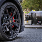 
              An electric Porsche Taycan is parked behind the bear statue in front of the stock market in Frankfurt, Germany, Wednesday, Sept. 28, 2022. German automaker Volkswagen is holding a share offering for a minority stake in its luxury division, Porsche. The shares are expected to start trading Thursday. (AP Photo/Michael Probst)
            