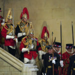 
              Royal guards change duties as the coffin of Queen Elizabeth II lies in state on the catafalque in Westminster Hall, in London, Sunday, Sept. 18, 2022. ( Jacob King/Pool Photo via AP)
            