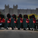 
              Guards march as the coffin of Queen Elizabeth II arrives outside Windsor Castle in Windsor, England, Monday, Sept. 19, 2022. The Queen, who died aged 96 on Sept. 8, will be buried at Windsor alongside her late husband, Prince Philip, who died last year. (AP Photo/Alastair Grant, Pool)
            