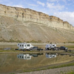 
              Campers are parked along the receding edge of Flaming Gorge Reservoir on Firehole Canyon on Friday, Aug. 5, 2022, in Wyoming (AP Photo/Rick Bowmer)
            