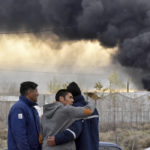 
              Residents watch as smoke rises from the New American Oil (NAO) refinery in Plaza Huincul, Neuquen province, Argentina,Thursday, Sept. 22, 2022. An explosion caused a major fire this morning at the NAO refinery, killing several people the town’s mayor said. (Fernando Ranni/Diario Rio Negro via AP)
            