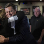 
              Massachusetts Republican gubernatorial candidate Geoff Diehl embraces a supporter at his primary night victory party, Tuesday, Sept. 6, 2022, in Weymouth, Mass. Diehl, a former GOP state representative from Whitman, Mass. endorsed by Donald Trump, beat businessman Chris Doughty for the chance to replace incumbent Republican Gov. Charlie Baker, who's opted not to seek a third term. (AP Photo/Josh Reynolds)
            