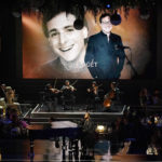 
              The late Bob Saget appears on screen during the In Memoriam tribute while John Legend performs at the 74th Primetime Emmy Awards on Monday, Sept. 12, 2022, at the Microsoft Theater in Los Angeles. (AP Photo/Mark Terrill)
            