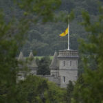
              A flag flaps in the wind at half staff on Balmoral Castle in Aberdeenshire, Scotland, Friday, Sept. 9, 2022. Queen Elizabeth II, Britain's longest-reigning monarch and a rock of stability across much of a turbulent century, died Thursday after 70 years on the throne. She was 96. (AP Photo/Alastair Grant)
            