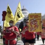 
              FILE - Fast food workers and their supporters march past the California state Capitol in Sacramento calling on the passage of a bill to provide increased power to fast food workers, Tuesday, Aug. 16, 2022. California Gov. Gavin Newsom on Monday, Sept. 6, 2022, signed a nation-leading measure giving more than a half-million fast food workers more power and protections, despite the objections of restaurant owners who warned it would drive up consumers’ costs. (AP Photo/Rich Pedroncelli, File)
            