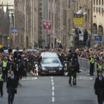 
              The procession with the coffin of Queen Elizabeth II, followed by King Charles III, Princess Anne and Prince Andrew, heads up the Royal Mile to St Giles' Cathedral in Edinburgh, Monday, Sept. 12, 2022. Britain's longest-reigning monarch who was a rock of stability across much of a turbulent century, died Thursday Sept. 8, 2022, after 70 years on the throne. She was 96. (AP Photo/Scott Heppell)
            