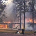 
              California Department of Forestry and Fire Protection firefighters try to stop flames from the Mill Fire from spreading on a property in the Lake Shastina subdivision northwest of Weed, Calif., Friday, Sept. 2, 2022. (Hung T. Vu/Special to The Record Searchlight via AP)
            