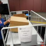 
              Gwinnett County elections supervisor Zach Manifold looks over boxes of voter challenges on Thursday, Sept. 15, 2022, in Lawrenceville, Ga. Manifold estimated his office has a month to log and research the challenges, before mail ballots go out for the November elections. “It is a tight window to get everything done,” he said. (AP Photo/John Bazemore)
            