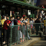 
              Commuters wearing face masks wait for a ride at a bus stop in Manila, Philippines Thursday, Sept. 8, 2022. Philippine President Ferdinand Marcos Jr. has approved a recommendation to end the mandatory wearing of face masks outdoors across the country more than two years after it was imposed at the height of the coronavirus pandemic, top officials said Wednesday. (AP Photo/Aaron Favila)
            