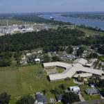 
              The Fifth Ward Elementary School and residential neighborhoods sit near the Denka Performance Elastomer Plant, back left, in Reserve, La., Friday, Sept. 23, 2022. Less than a half mile away from the elementary school the plant, which is under scrutiny from federal officials, makes synthetic rubber, emitting chloroprene, listed as a carcinogen in California, and a likely one by the Environmental Protection Agency. (AP Photo/Gerald Herbert)
            