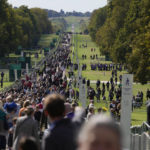 
              People make their way along the Long Walk towards Cambridge gate outside Windsor Castle to lay flowers for the late Queen Elizabeth II in Windsor, England, Saturday, Sept. 17, 2022. The Queen will lie in state in Westminster Hall for four full days before her funeral on Monday Sept. 19. (AP Photo/Gregorio Borgia)
            