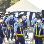 
              Police officers stand guard around the Nippon Budokan, the venue for a state funeral for Japan's former Prime Minister Shinzo Abe, in Tokyo Tuesday, Sept. 27, 2022. Japan is filled with tension, rather than sadness, on Tuesday as the rare state funeral for the assassinated former Prime Minister Abe, one of the most divisive leader, deeply splits the nation. (Yohei Fukai/Kyodo News via AP)
            