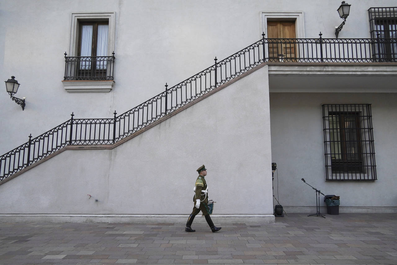 An honor guard walks at La Moneda presidential palace in Santiago, Chile, Monday, Sept. 5, 2022. Ch...