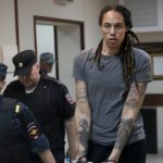 
              FILE - WNBA star and two-time Olympic gold medalist Brittney Griner is escorted from a courtroom after a hearing in Khimki just outside Moscow, Russia, Aug. 4, 2022. The Biden administration should create a new position at the White House National Security Council to focus on cases of Americans wrongfully detained in foreign countries. That's according to a report from an advocacy group, which recommends funding an interagency office to help free hostages. The U.S. has been trying to bring home Griner and another American jailed in Russia, Paul Whelan, but those efforts have so far not been successful. (AP Photo/Alexander Zemlianichenko, File)
            