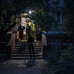 
              People stand at the entrance of a residential building that was damaged after a Russian attack in Kramatorsk, Ukraine, Monday, Sept. 26, 2022. (AP Photo/Leo Correa)
            