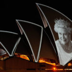 
              The Sydney Opera House is illuminated with a portrait of Queen Elizabeth II in Sydney, Australia, Friday, Sept. 9, 2022. Queen Elizabeth II, Britain's longest-reigning monarch and a rock of stability in a turbulent era for her country and the world, died Thursday, Sept. 8 after 70 years on the throne. She was 96. (AP Photo/Mark Baker)
            