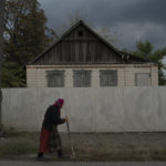 
              An elderly woman walks on a street in Raihorodok, Ukraine, Monday, Sept. 26, 2022. (AP Photo/Leo Correa)
            