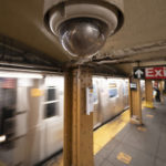 
              FILE - A video surveillance camera hangs from the ceiling above a subway platform, Wednesday, Oct. 7, 2020 in the Brooklyn borough of New York. All subway cars in New York will soon be equipped with security cameras in an effort to keep riders safe and solve crimes happening in train stations, New York Governor Kathy Hochul announced Tuesday, Sept. 20. The Metropolitan Transportation Authority New York City Transit received about $5.5 million in state and federal funding for purchasing and installing cameras on about 6,355 subway cars. (AP Photo/Mark Lennihan, File)
            