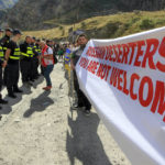 
              Georgian police form a line in front of activists holding an anti-Russian banner during an action organized by political party Droa near the border crossing at Verkhny Lars between Georgia and Russia in Georgia, Wednesday, Sept. 28, 2022. Protesters come from Tbilisi to voice their concerns over the exodus of Russian citizens into Georgia, that has increased since Vladimir Putin announced partial mobilization. (AP Photo/Shakh Aivazov)
            