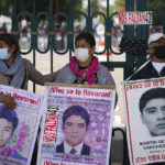
              Relatives of the missing 43 Ayotzinapa students hold signs that read in Spanish "You took them alive, We want them back alive" during a protest outside a military base in Mexico City, Friday, Sept. 23, 2022, days before the anniversary of the disappearance of the students in Iguala, Guerrero in 2014. One week prior, Mexican authorities said they arrested a retired general and three other members of the army for alleged connection to their disappearance. (AP Photo/Fernando Llano)
            
