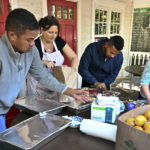 
              Volunteers prepare food for immigrants outside St. Andrews Episcopal Church, Thursday Sept. 15, 2022, in Edgartown, Mass., on Martha's Vineyard. Florida Gov. Ron DeSantis on Wednesday flew two planes of immigrants to Martha's Vineyard, escalating a tactic by Republican governors to draw attention to what they consider to be the Biden administration's failed border policies. (Ron Schloerb/Cape Cod Times via AP)
            