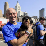 
              Democratic House candidate Greg Landsman poses for a photo as he holds Jerome the dachshund prior to the Running Of The Wieners race, as part of Oktoberfest Zinzinnati, Friday, Sept. 16, 2022, in Cincinnati. (AP Photo/Aaron Doster)
            
