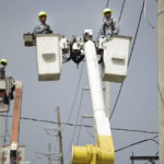 
              FILE - Puerto Rico Electric Power Authority workers repair distribution lines damaged by Hurricane Maria in the Cantera community of San Juan, Puerto Rico, on Oct. 19, 2017. Five years after Maria slammed into Puerto Rico and exposed the funding problems the Caribbean island has long faced, philanthropists warn that many of those issues remain unaddressed, just like the repairs still needed for the American territory’s physical infrastructure. (AP Photo/Carlos Giusti, File)
            