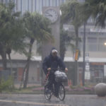 
              A man on a bicycle makes his way through the rain in Miyazaki, southern Japan, Sunday, Sept. 18, 2022, as a powerful typhoon approaching southern Japan on Sunday lashed the region with strong winds and heavy rain.(Kyodo News via AP)
            