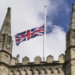 
              The Union Jack is set on half-mast at a church outside Windsor Castle, in Windsor, England, Sunday, Sept. 11, 2022. Queen Elizabeth II, Britain's longest-reigning monarch died Thursday Sept. 8, 2022, after 70 years on the throne. (AP Photo/Martin Meissner)
            