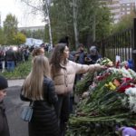 
              People gather to lay flowers, put toys and light candles in memory of victims of the shooting at school No. 88 in Izhevsk, Russia, Monday, Sept. 26, 2022. Authorities say a gunman has killed 15 people and wounded 24 others in a school in central Russia. According to officials, 11 children were among those killed in the Monday morning shooting in School No. 88 in Izhevsk, a city 960 kilometers (600 miles) east of Moscow in the Udmurtia region. (AP Photo/Sergei Kuznetsov)
            