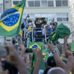 
              President Jair Bolsonaro greets supporters in Copacabana beach during the celebrations of the bicentennial of the country's independence in Rio de Janeiro, Brazil, Wednesday, Sept. 7, 2022. (AP Photo/Rodrigo Abd)
            