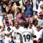 
              Real Madrid's Federico Valverde, left, celebrates with Real Madrid's Dani Ceballos after scoring his side's first goal during the Spanish La Liga soccer match between Real Madrid and Mallorca at the Santiago Bernabeu stadium in Madrid, Spain, Sunday, Sept. 11, 2022. (AP Photo/Manu Fernandez)
            