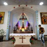 
              FILE - A parishioner walks past the altar during an impromptu prayer vigil as members of Lower Dafei Catholic Church wait for Chinese police, security guards, and government workers to arrive and cut down their church's cross in Lower Dafei Village in Lower Dafei Village in Yongjia County in eastern China's Zhejiang Province on July 30, 2015. Chinese President Xi Jinping's first trip overseas since the early days of the COVID-19 pandemic will overlap with a visit by Pope Francis to Kazakhstan, although the Vatican says there are no plans for them to meet. Under Xi, China has launched a crackdown on Christianity in recent years, part of an overall tightening on religious freedoms which has affected worshippers of Islam, Christianity, and to a lesser extent, Buddhism and Daoism. (AP Photo/Mark Schiefelbein, File)
            