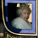
              FILE - In this Nov. 6, 2007 file photo Britain's Queen Elizabeth II leaves Buckingham Palace in the State Coach, to attend the State opening of Parliament in London.  Queen Elizabeth II, Britain’s longest-reigning monarch and a rock of stability across much of a turbulent century, has died. She was 96. Buckingham Palace made the announcement in a statement on Thursday Sept. 8, 2022.(AP Photo/Kirsty Wigglesworth, File)
            