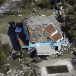 
              CORRECTS DATELINE TO FORT MYERS BEACH, NOT FORT MYERS - A damaged home and debris is seen in the aftermath of Hurricane Ian, Thursday, Sept. 29, 2022, in Fort Myers Beach, Fla. (AP Photo/Wilfredo Lee)
            