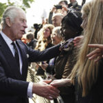 
              Britain's King Charles III meets members of the public in the queue along the South Bank, near to Lambeth Bridge as they wait to view Queen Elizabeth II lying in state ahead of her funeral on Monday, in London, Saturday, Sept. 17, 2022. (Aaron Chown/Pool Photo via AP)
            