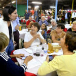 
              Elly Schlein, left, an independent candidate who runs with the Democratic Party, talks with some women during an electoral rally in Modena, Italy, Friday, Sept. 2, 2022. Schlein, a 37-year-old U.S.-Italian national, often compared with U.S. Rep. Alexandria Ocasio-Cortez for her platform advocating social justice is on the road in a national campaign aimed at challenging the overriding storyline that the united right will easily defeat the left in the Sept. 25 vote. (AP Photo/Marco Vasini)
            