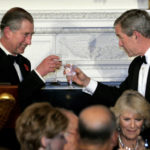 
              FILE - Britain's Prince Charles makes a toast with President George W. Bush at the start of a Social Dinner in the State Dining Room of the White House, Nov. 2, 2005, in Washington. The dinner is honor of Prince Charles and Camilla, Duchess of Cornwall, seen seated foreground right. (AP Photo/Lawrence Jackson, File)
            