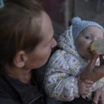 
              Margaryta Tkachenko, 29 years old, feeds her 9-month-old daughter Sophia in the recently retaken town of Izium, Ukraine, Sunday, Sept. 25, 2022. (AP Photo/Evgeniy Maloletka)
            