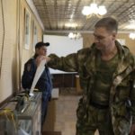 
              FILE A Luhansk People's Republic serviceman votes in a polling station in Luhansk, Luhansk People's Republic, controlled by Russia-backed separatists, eastern Ukraine, Friday, Sept. 23, 2022. Voting began Friday in four Moscow-held regions of Ukraine on referendums to become part of Russia. (AP Photo, File)
            