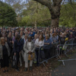 
              People stand in a queue to pay their respects to the late Queen Elizabeth II during the Lying-in State, in Southwark park in London, Friday, Sept. 16, 2022. The Queen will lie in state in Westminster Hall for four full days before her funeral on Monday Sept. 19. (AP Photo/Nariman El-Mofty)
            