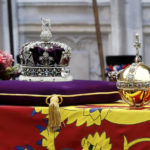 
              The coffin of Queen Elizabeth II with the Imperial State Crown resting on top is carried into Westminster Abbey during the State Funeral of Queen Elizabeth II, in London, Monday Sept. 19, 2022. (Tristan Fewings/Pool Photo via AP)
            