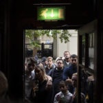 
              People gather outside a pub to watch a broadcast of Britain's King Charles III first address to the nation following the death of Queen Elizabeth II in London, Friday, Sept. 9, 2022. Queen Elizabeth II, Britain's longest-reigning monarch and a rock of stability across much of a turbulent century, died Thursday Sept. 8, 2022, after 70 years on the throne. She was 96. (AP Photo/Felipe Dana)
            