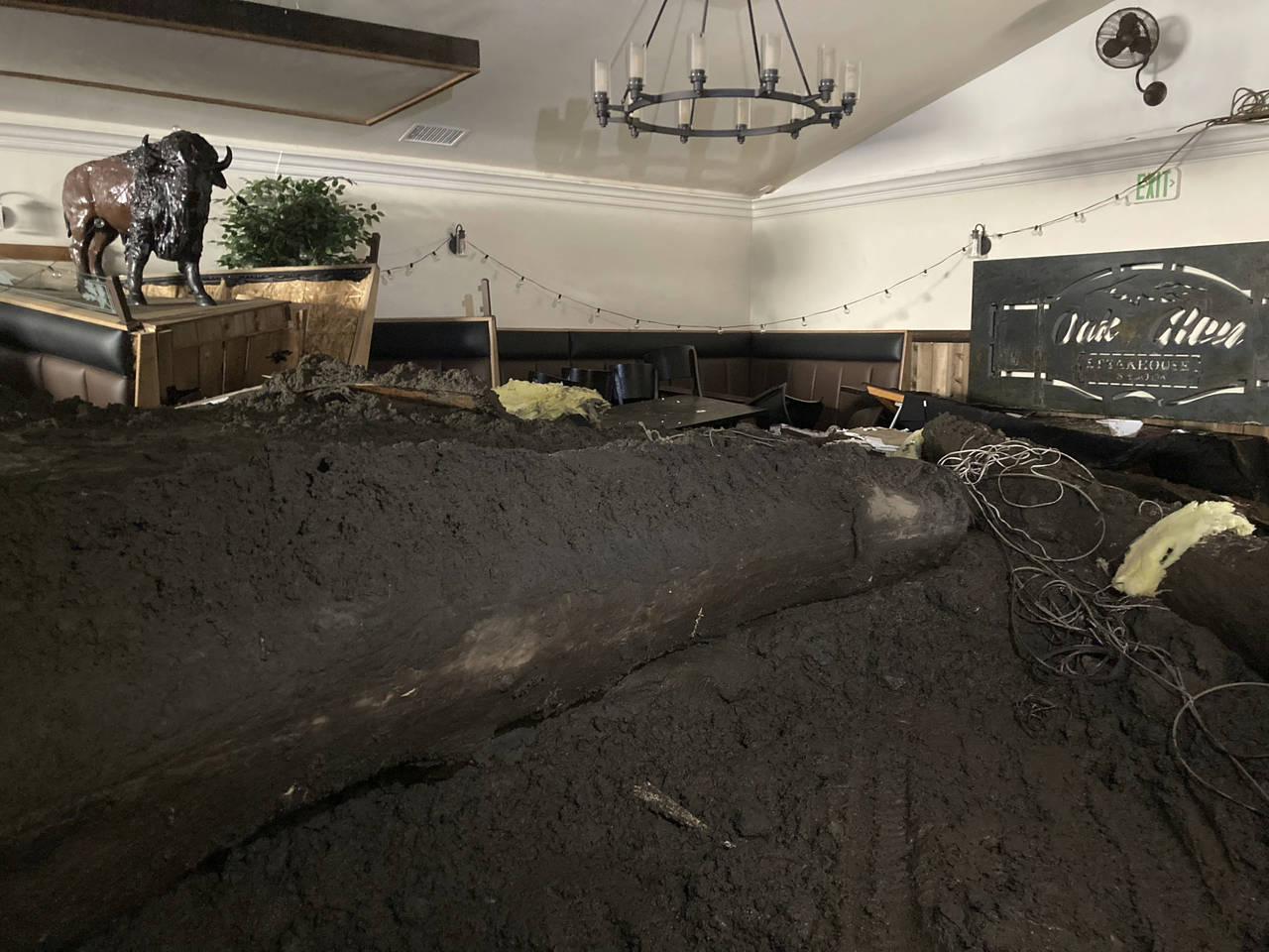 Extensive damage from a slow-moving black river of sludge is seen inside the Oak Glen Steakhouse an...