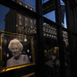 
              A photo of late Queen Elizabeth II is placed in the window display of a boutique, in London, Saturday, Sept. 17, 2022. The Queen lays in state in Westminster Hall ahead of her funeral on Monday Sept. 19. (AP Photo/Nariman El-Mofty)
            