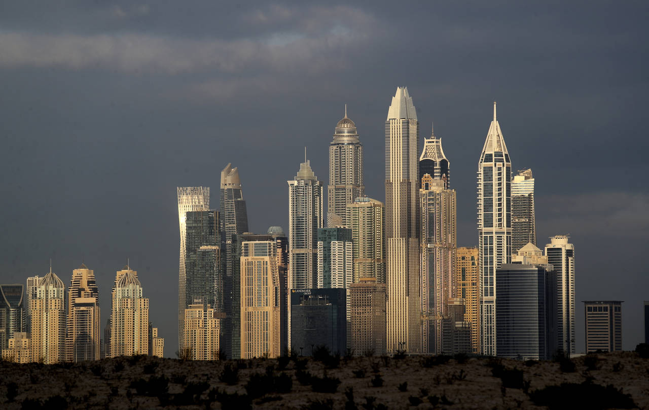FILE - The sun reflects on skyscrapers in Dubai, United Arab Emirates,  Feb. 27, 2021. The UAE has ...