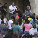 
              An administrator attempts to quell a crowd of parents and family members gathered outside of Thomas Jefferson High School in San Antonio, after the school went into lockdown on Tuesday, Sept. 20, 2022. Alarmed parents laid siege to the Texas high school Tuesday after a classroom shooting report that ultimately proved to be false.  (Kin Man Hui/The San Antonio Express-News via AP)
            